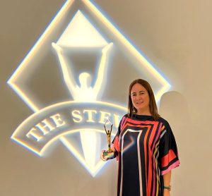 Image of Marian Merino receiving the Gold Stevie award for Innovative Achievement in Human Resources