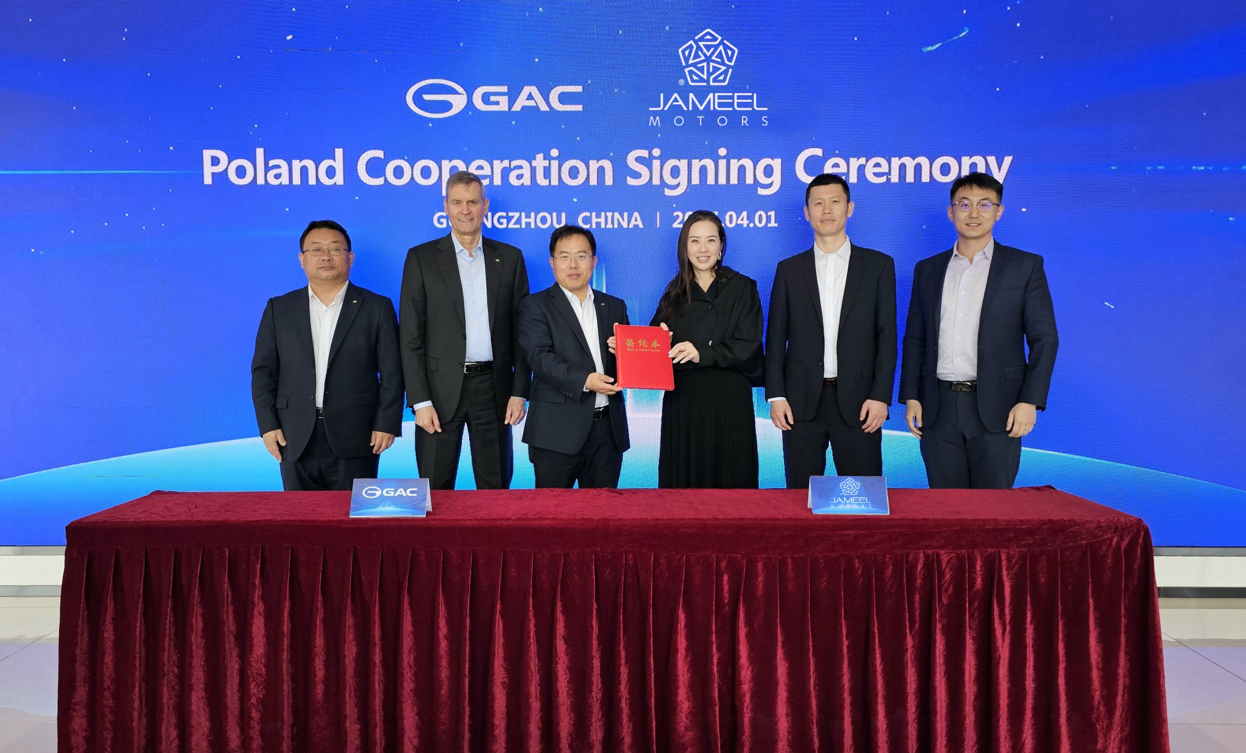 This image has an empty alt attribute; its file name is Jameel-Motors-GAC-Poland-Signing-Ceremony-1-591x357.jpg